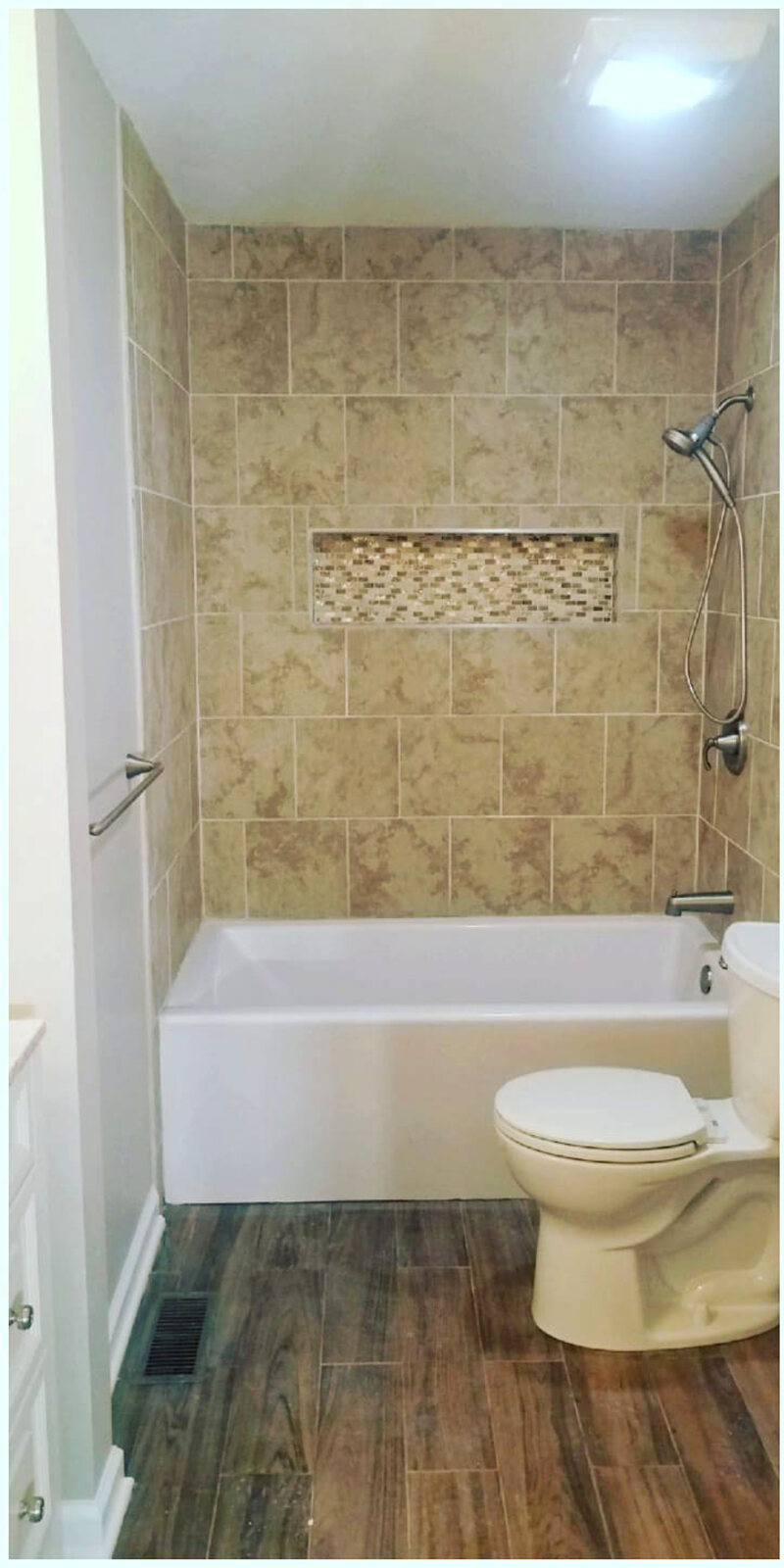 After: new tiled tub surround and wood-look floor