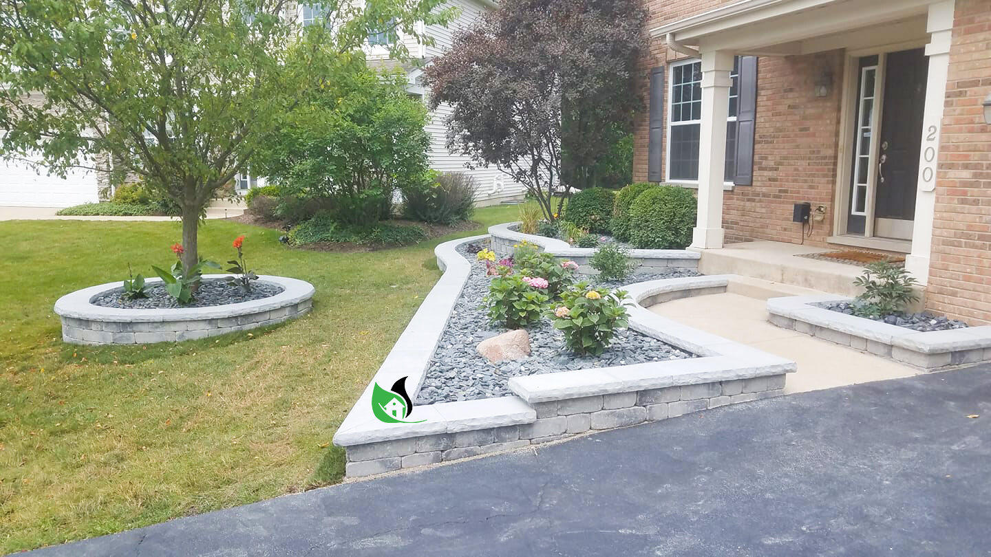 Front-yard retaining wall with planting beds and stone