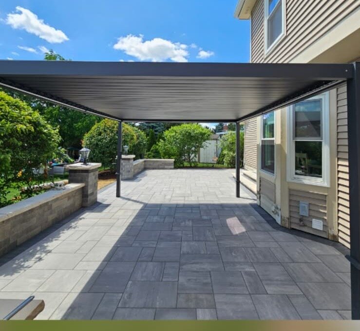 After: modern pergola over a new paver patio with seating wall