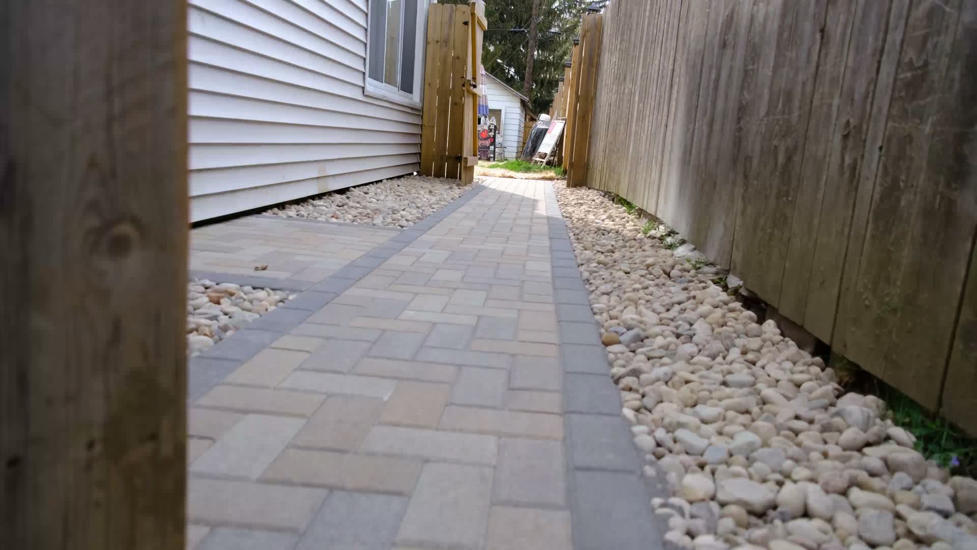 After: finished paver walkway with river rock border