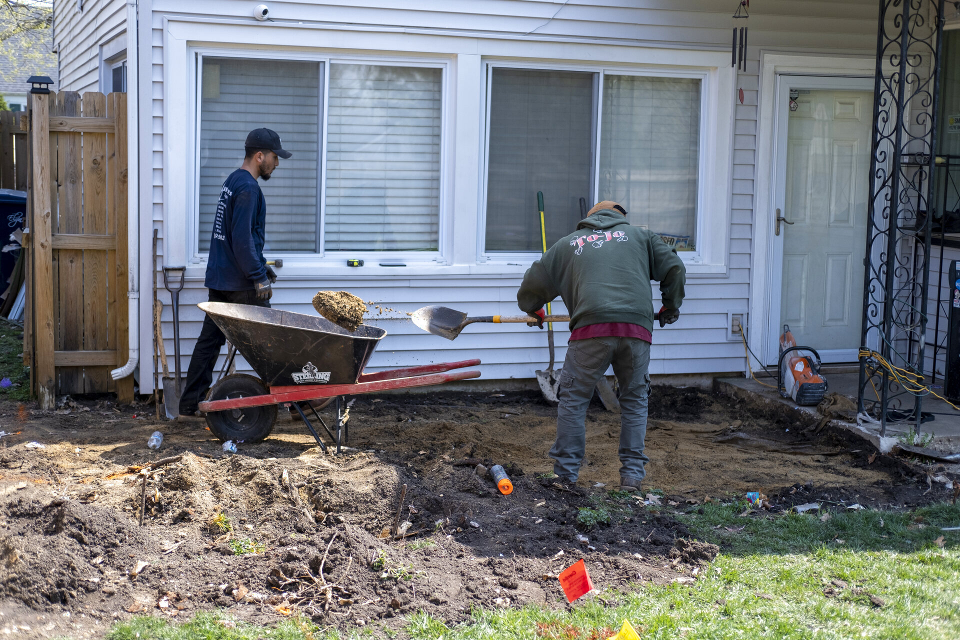 Side yard before: crew excavating along the house