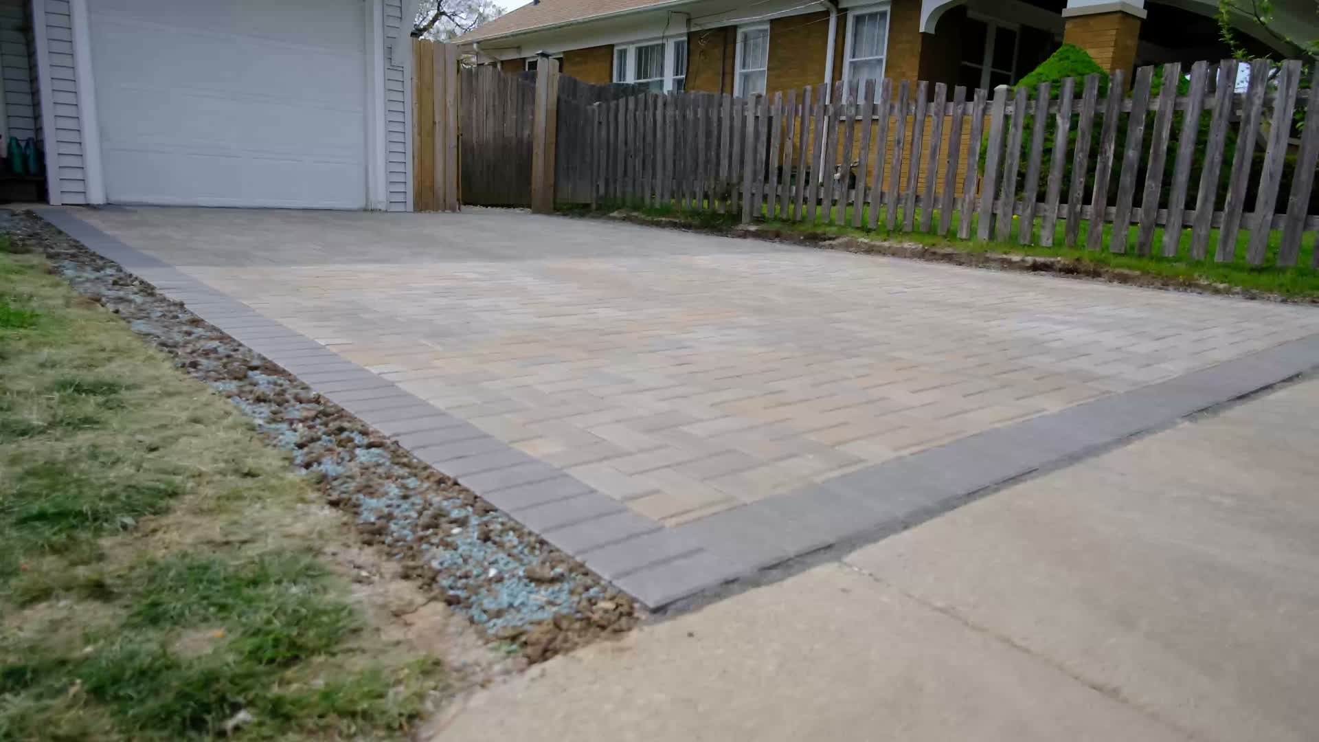 After: finished paver parking pad with charcoal border